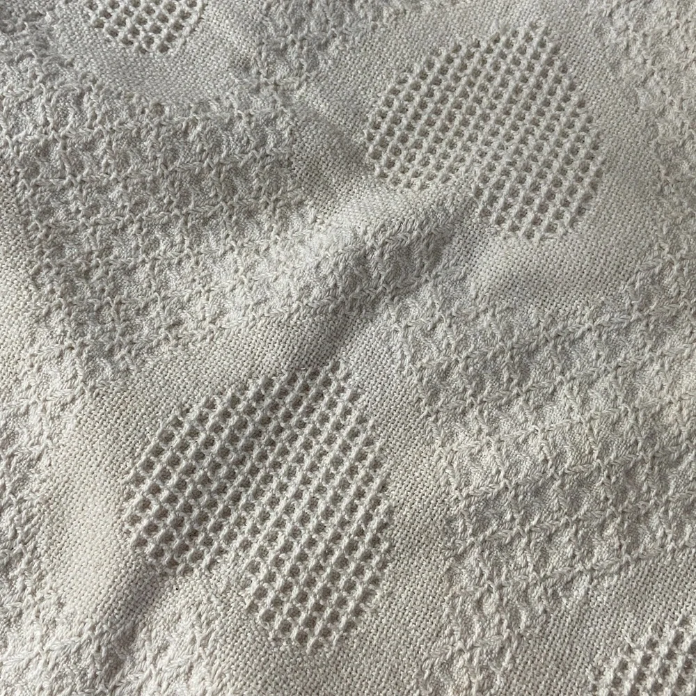 Beautiful white blanket with subtle heart detail.